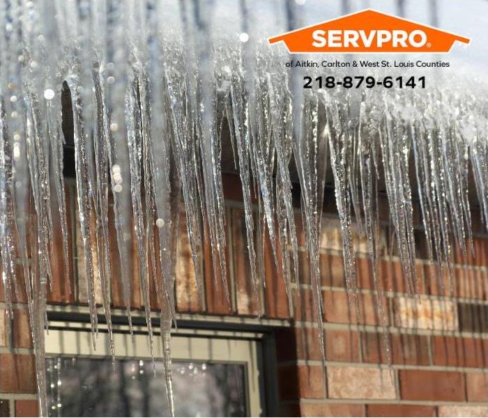 Icicles cling to a roofline.