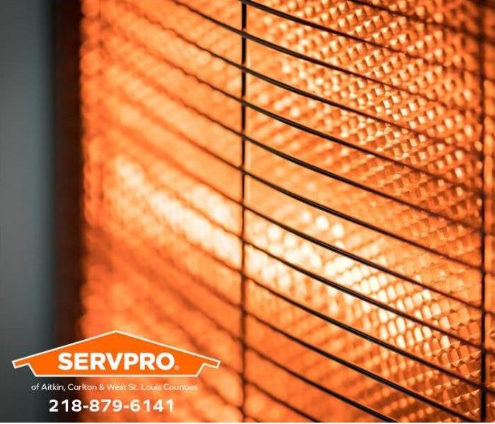 Heated coils radiate heat on a home's wall heater.
